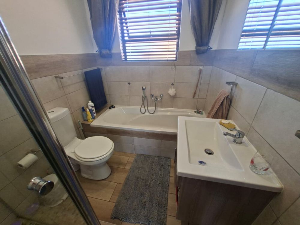 First bathroom with shower and bath