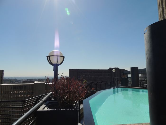 For Sale: 1-Bedroom Apartment in Braamfontein with Hotel Amenities and Security.