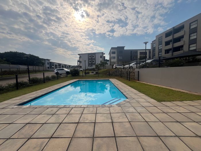 For Sale: 2-Bed Flat in Umbogintwini with pool, braai area, and security.