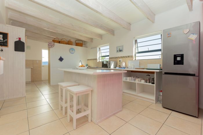 House for Sale in Dwarskersbos: Beachfront access, garden, indoor braai, investment potential.