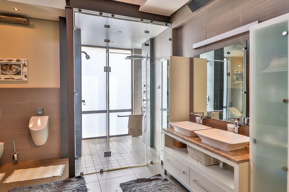 Master bathroom has double vanity, freestanding bath and shower and urinal