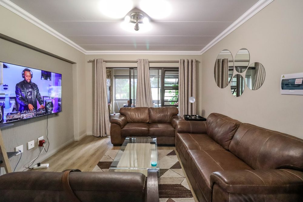 Open plan lounge with glass sliding doors that lead to the braai area