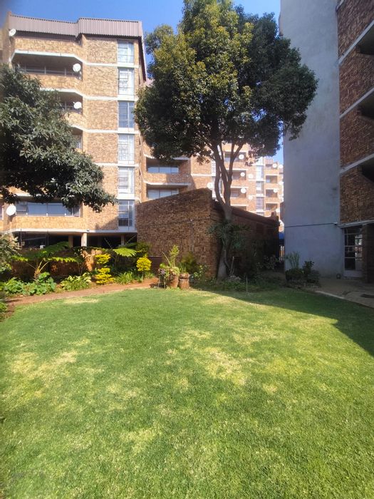 2-Bedroom Flat For Sale in Pretoria North with balcony, secure parking, and amenities.