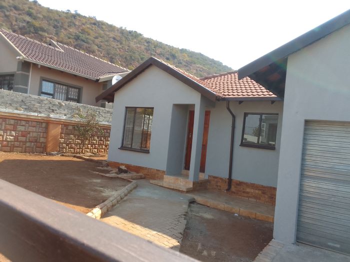 House for Sale in Tlhabane West: 3 beds, 2 baths, garage, yard with fruit trees.