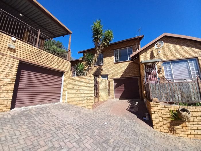 For Sale: Townhouse in Safari Gardens with garage, pools, and fishing pond.