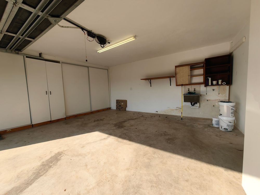 Double garage with extra cupboard space, and plumbing for laundry