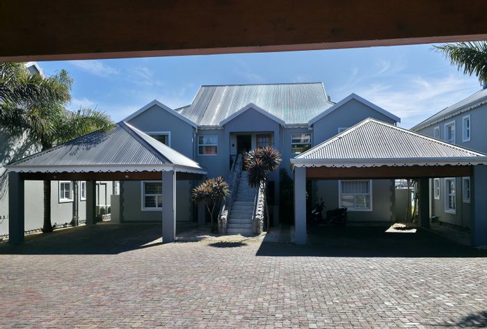 Canal-side apartment in Marina Martinique for sale, beach access, secure living.