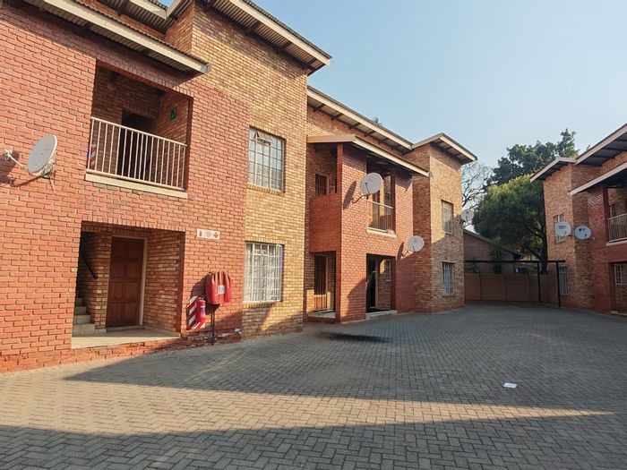 2-Bedroom Apartment For Sale in Rustenburg Central with private backyard and parking.