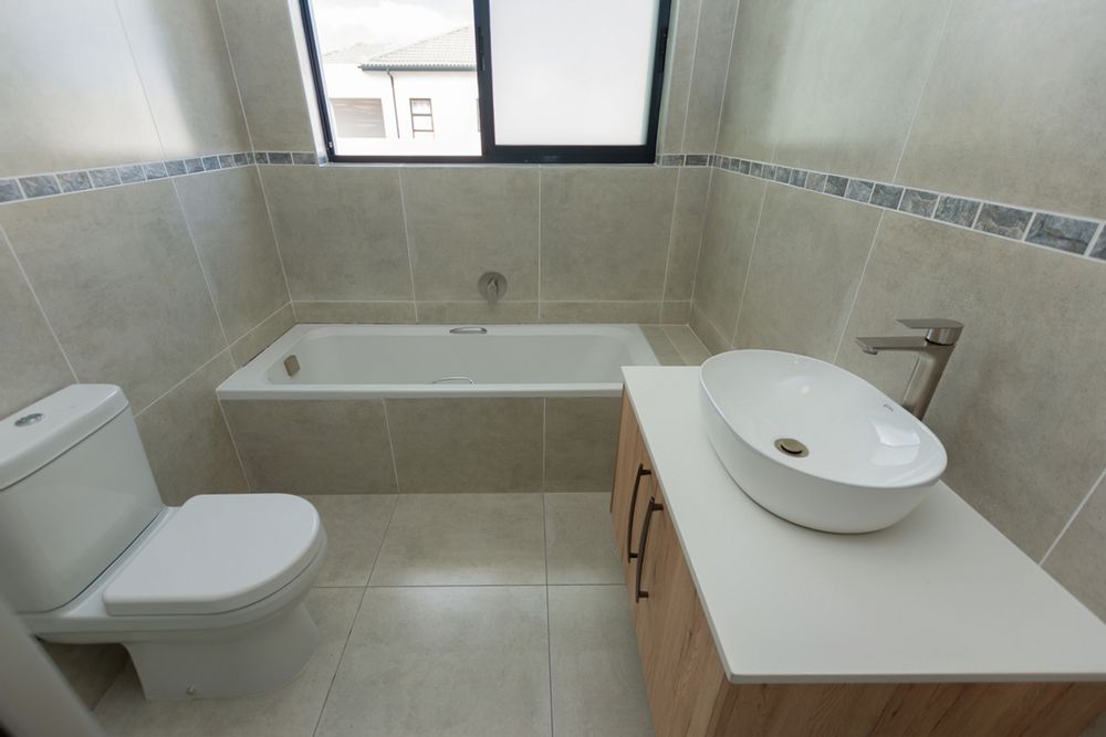 Full guest bathroom with sliding window
