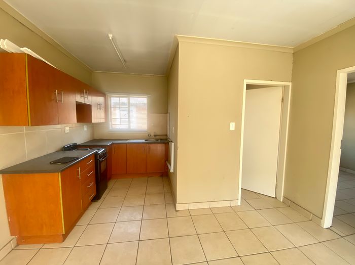 For Sale: 2-Bedroom Apartment in Rustenburg Central with open living space and parking.