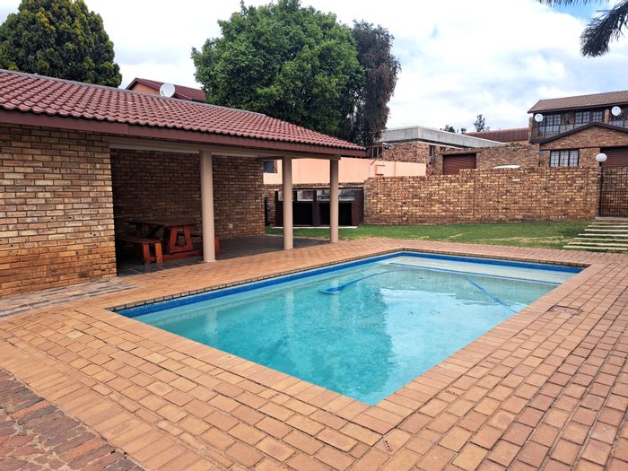 2-Bedroom Townhouse To Rent in Weltevreden Park with pool, braai area, and security.