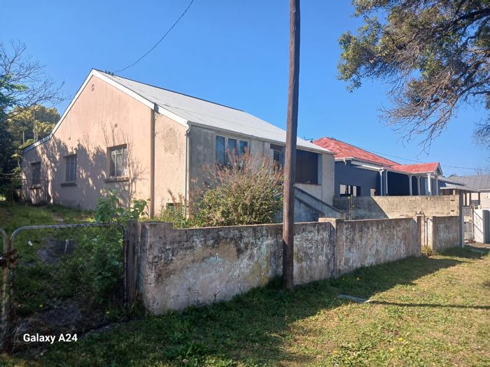 For Sale: House in Cambridge with large yard, outbuildings, and renovation potential.