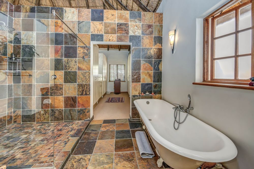 Main en-suite bathroom with dressing room in the background