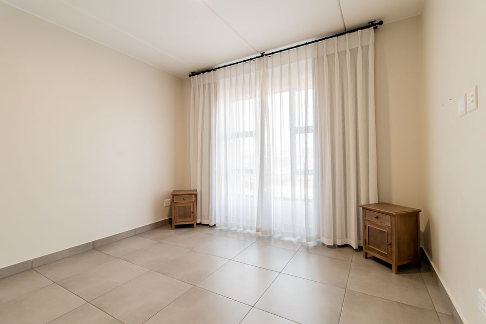 Master bedroom includes curtaining.