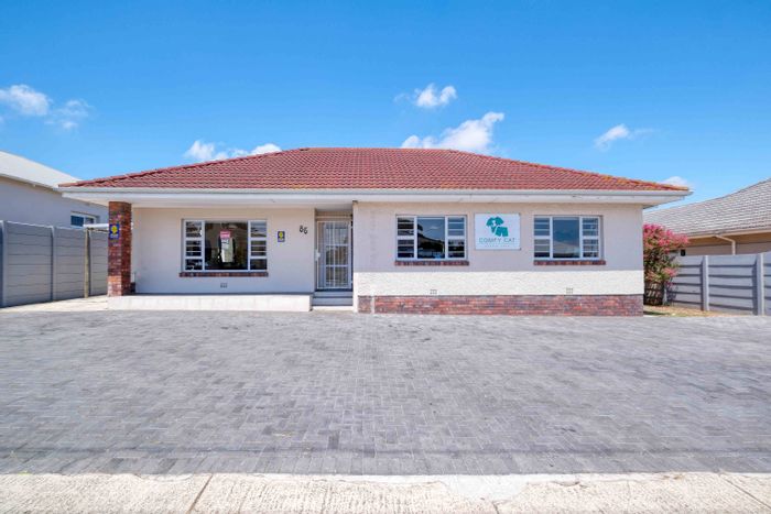 For Sale: House in Newton Park with three bedrooms, two garages, and rezoning potential.