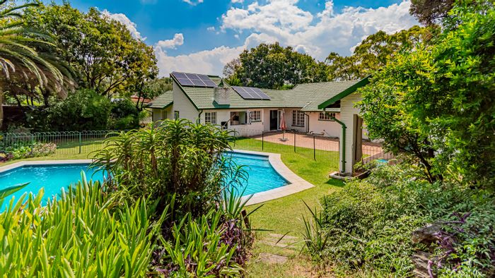 Spacious 4-bedroom house in Robin Acres with pool, garden cottage, and solar panels. For Sale.