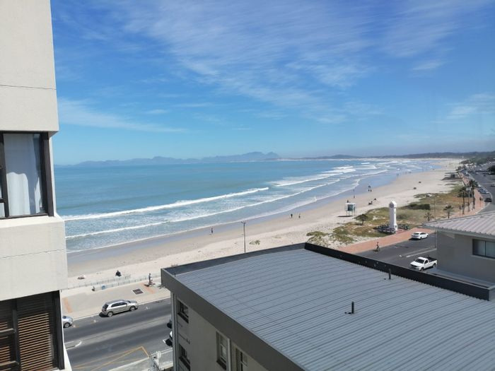 3-Bedroom Apartment To Rent in Strand Central with sea views and garage parking.