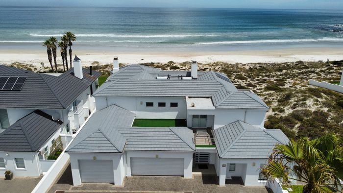 Beachfront house in Shelley Point for sale, featuring 6 bedrooms, garages, and jacuzzi.
