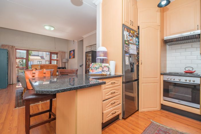 For Sale: Spacious Douglasdale townhouse with pools, tennis courts, and secure living.