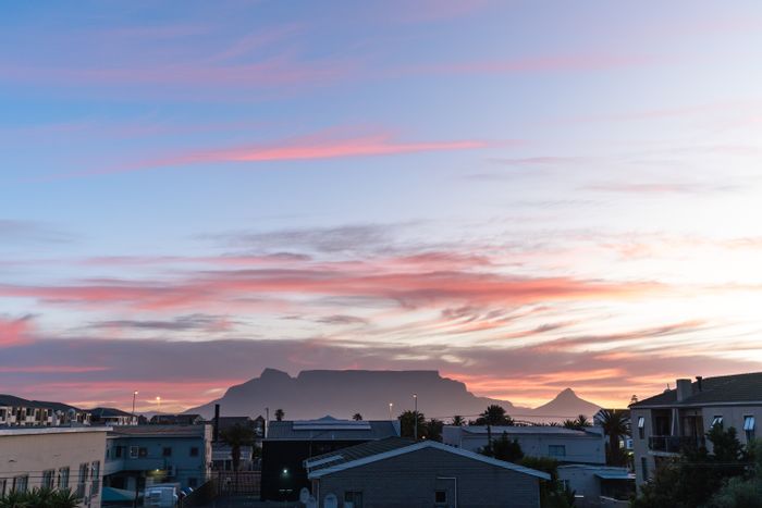 To Rent: 2-Bedroom Apartment in Table View with balcony, garage, and beach access.