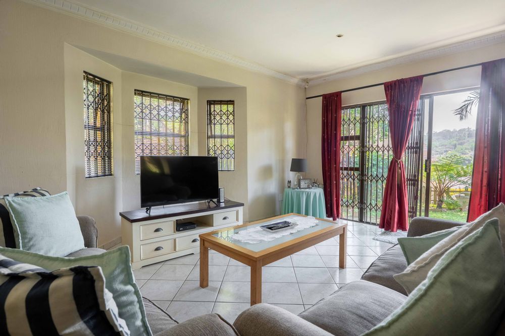 Open plan living area with sliding door leading to the garden