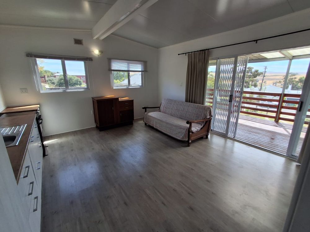 open plan kitchen and lounge leading to deck