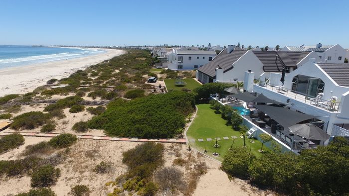 Beachfront house in Britannia Bay for sale with pool, guest suite, and ocean views.