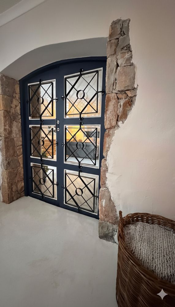 Unique charming doors leading to bedroom