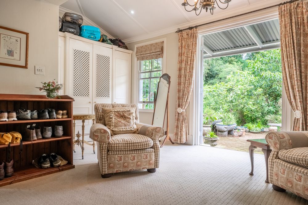 Bedroom 1 - Features ceiling fan, en-suite bathroom, walk-in closet & double doors to the outside