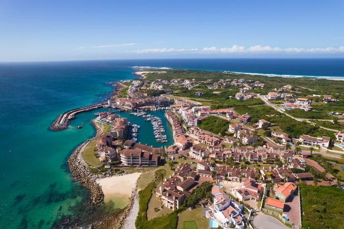 For Sale: Apartment in Port St Francis with pool, beach access, and garage.