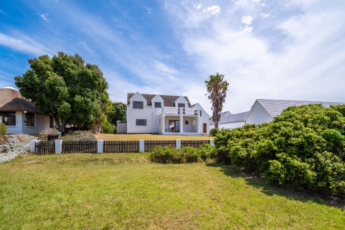 For Sale: House in St Francis Bay Village, golf course access, versatile living spaces.