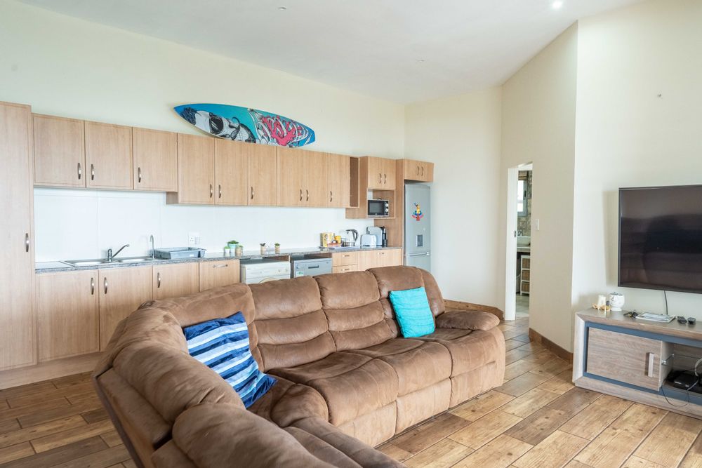 Living area with kitchen in back of flat