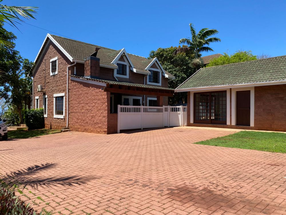 Back of property showing large level dirveway and parking area