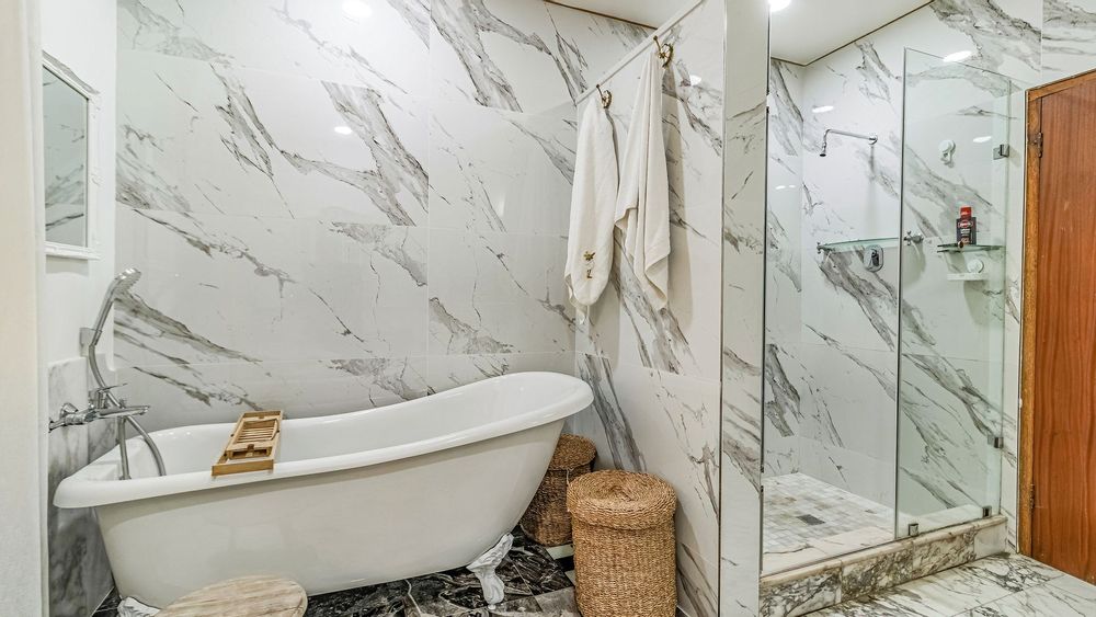 Main en suite bathroom with a slipper bath and shower