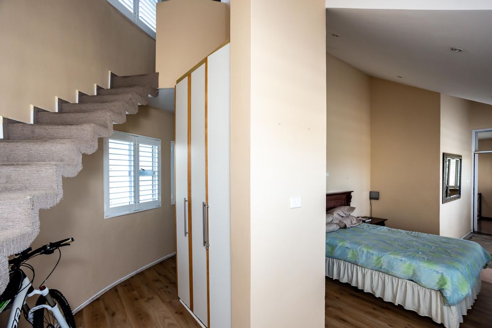Main Bedroom with a study leading up the stairway. En suite around the corner