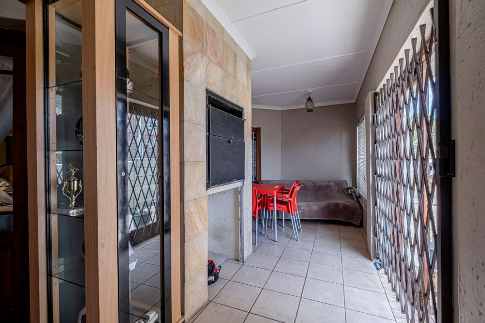 Braai area with doors leading to back garden.