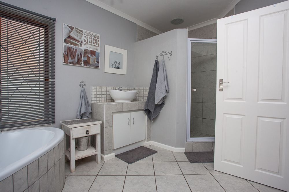 En-suite with his and her basin, shower and bath