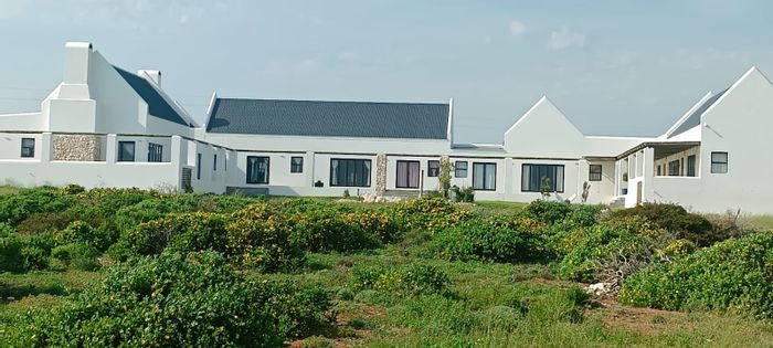For Sale: Spacious 7-bedroom house in Jacobsbaai with ocean views and flexible layout.