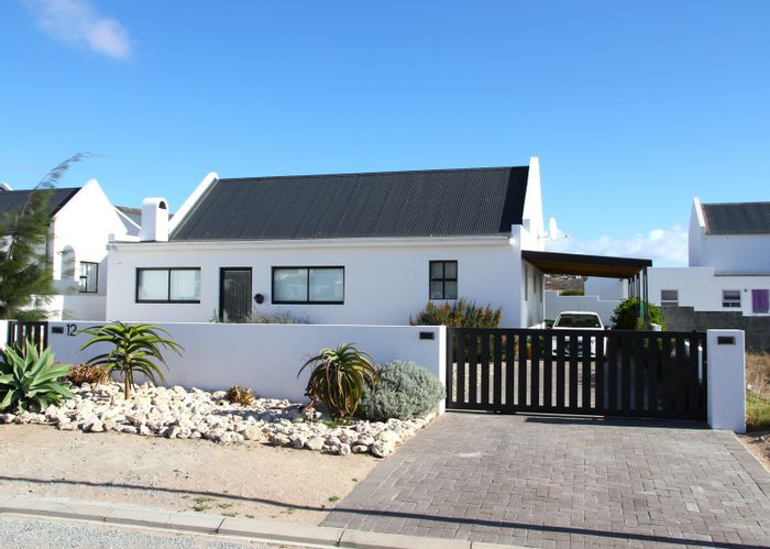 House For Sale in Sandpyper Village: Sea views, indoor braai, low-maintenance garden.