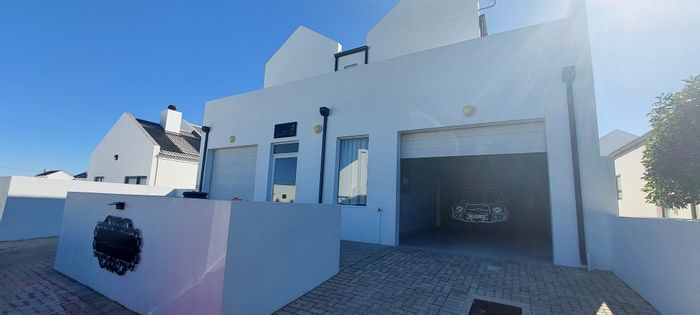 Dual-living house for sale in Golden Mile, steps from the beach.
