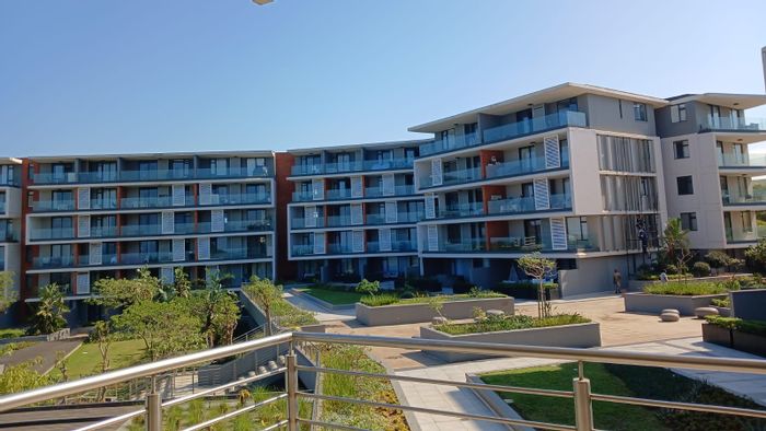 Sibaya Precinct Apartment To Rent: 1 bed, pool, gym, secure parking, coastal access.