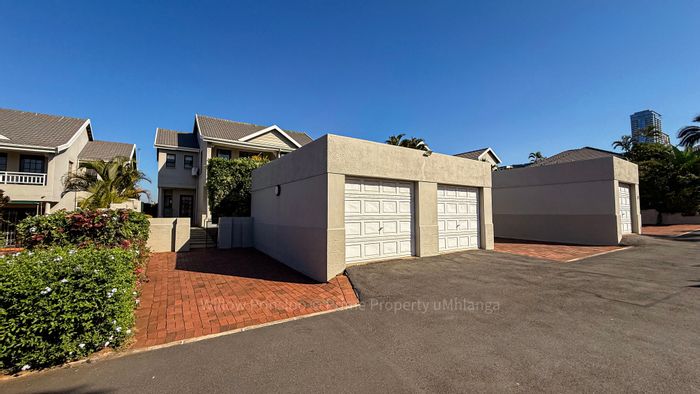 For Sale: 2-Bedroom Townhouse in Umhlanga Central with pool and garage access.