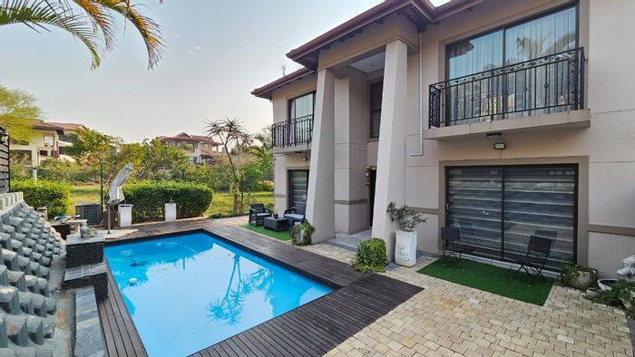 For Sale: 4-bedroom townhouse in Izinga Estate with pool, bar, and estate amenities.