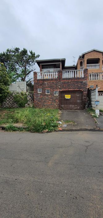 For Sale: Forest Haven House with rental unit, balconies, and dual driveway access.