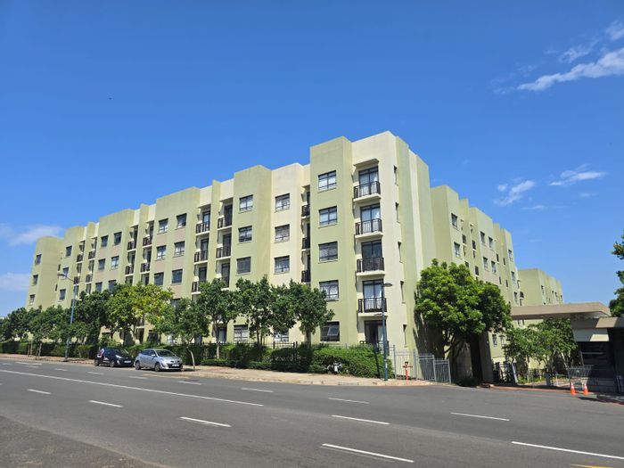 For Sale: 2-Bedroom Apartment in New Town Centre with garden, pool, and secure parking.