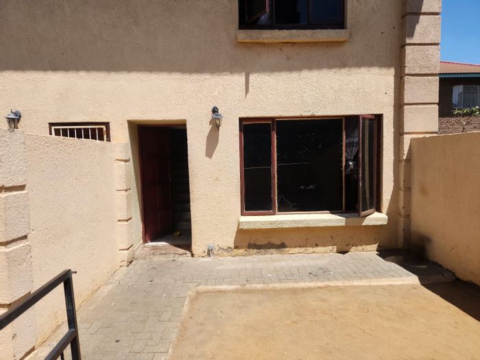 Townhouse For Sale in Rustenburg Central: 2 beds, yard, carport, near amenities.
