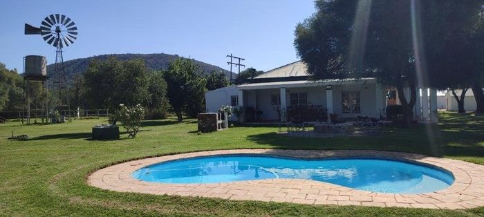 Farm for Sale in Groot Marico Central: River access, renovated farmhouse, ample amenities.