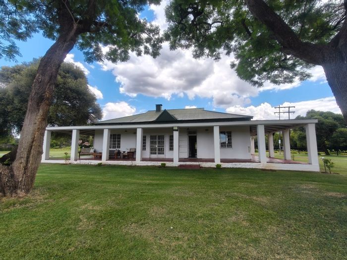 Farm for Sale in Groot Marico Central: River access, renovated farmhouse, ample amenities.