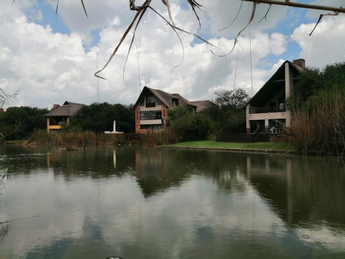 Boschenvaal River Front Lodges: House for Sale with river access, pool, and entertainment areas.