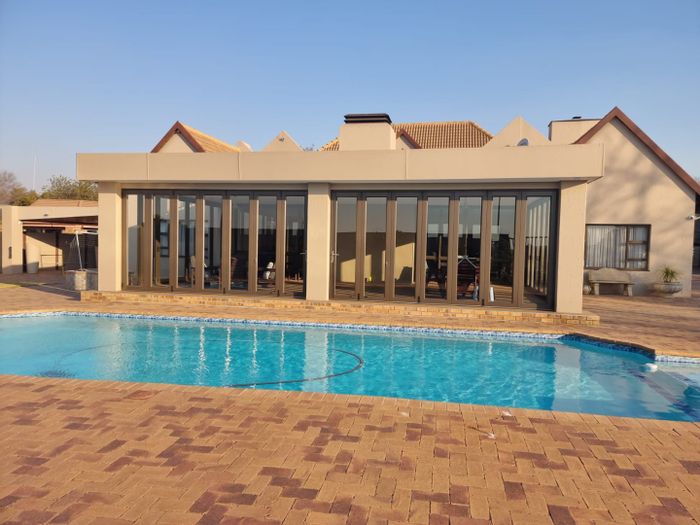 House for sale in Vaalpark: 4 bedrooms, pool, double garages, and entertainment area.